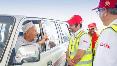 Shell Helix attendant speaking with man