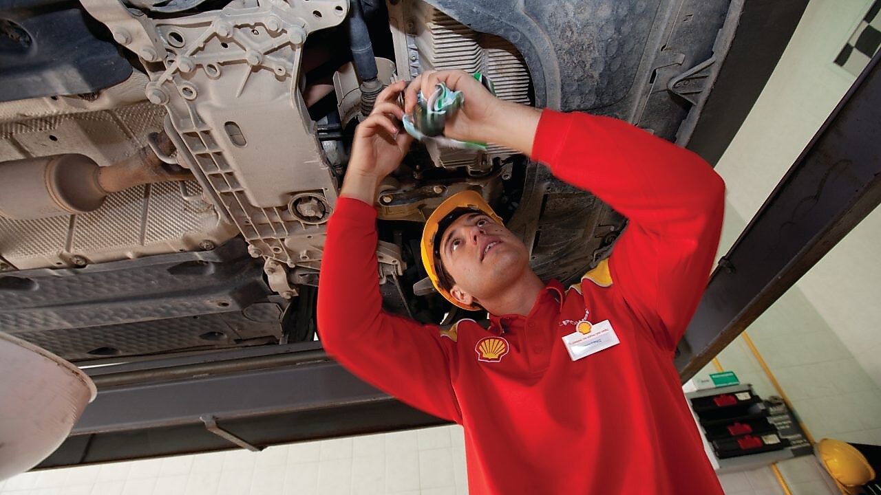 employee doing fitting of parts in car