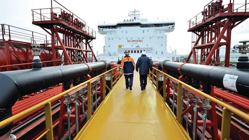 Shell employee walking along on a tanker