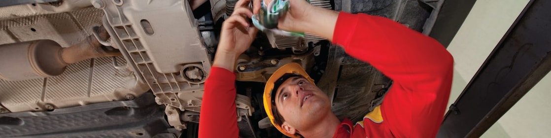 employee doing fitting of parts in car