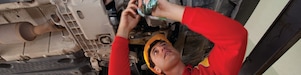 employee doing fitting of parts in car