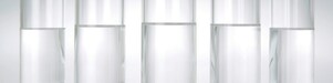 Five beakers in a row with a clear liquid in each one