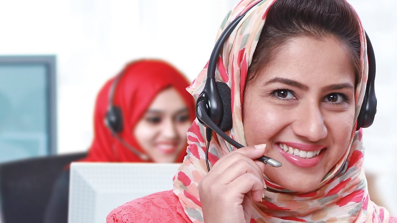 Women wearing headphones and mic answering calls in a call centre,Singapore 2008