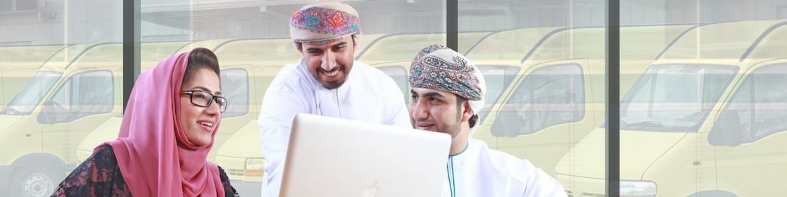 Two mean and a women sitting in front of a laptop