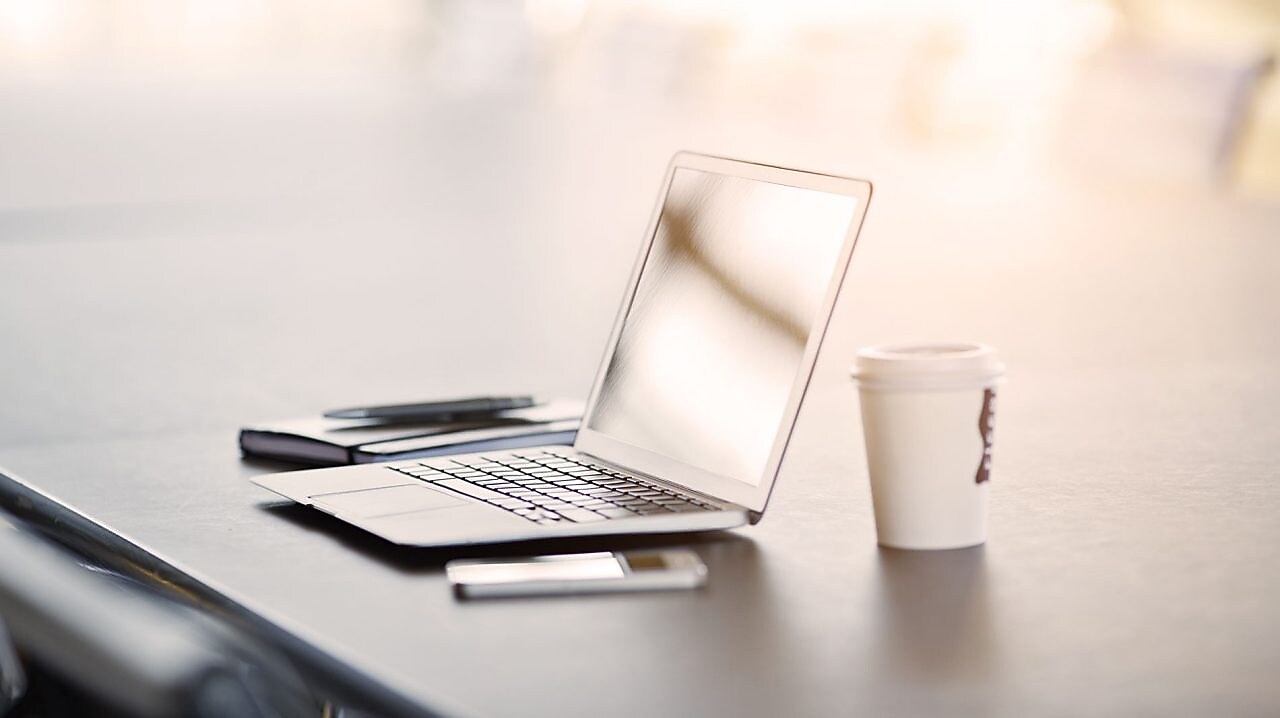 laptop, mobile phone and coffee on a desk