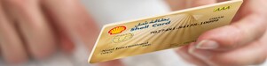 Person holding Shell card 