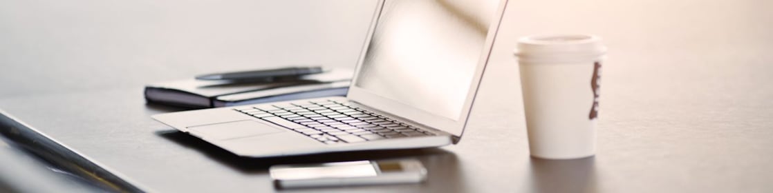 laptop, mobile phone and coffee on a desk