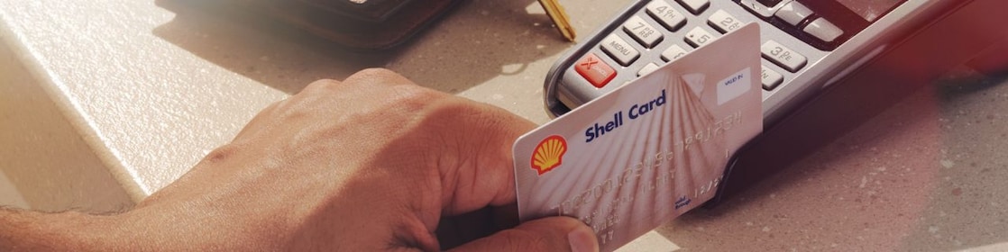person swiping shell card in reader machine
