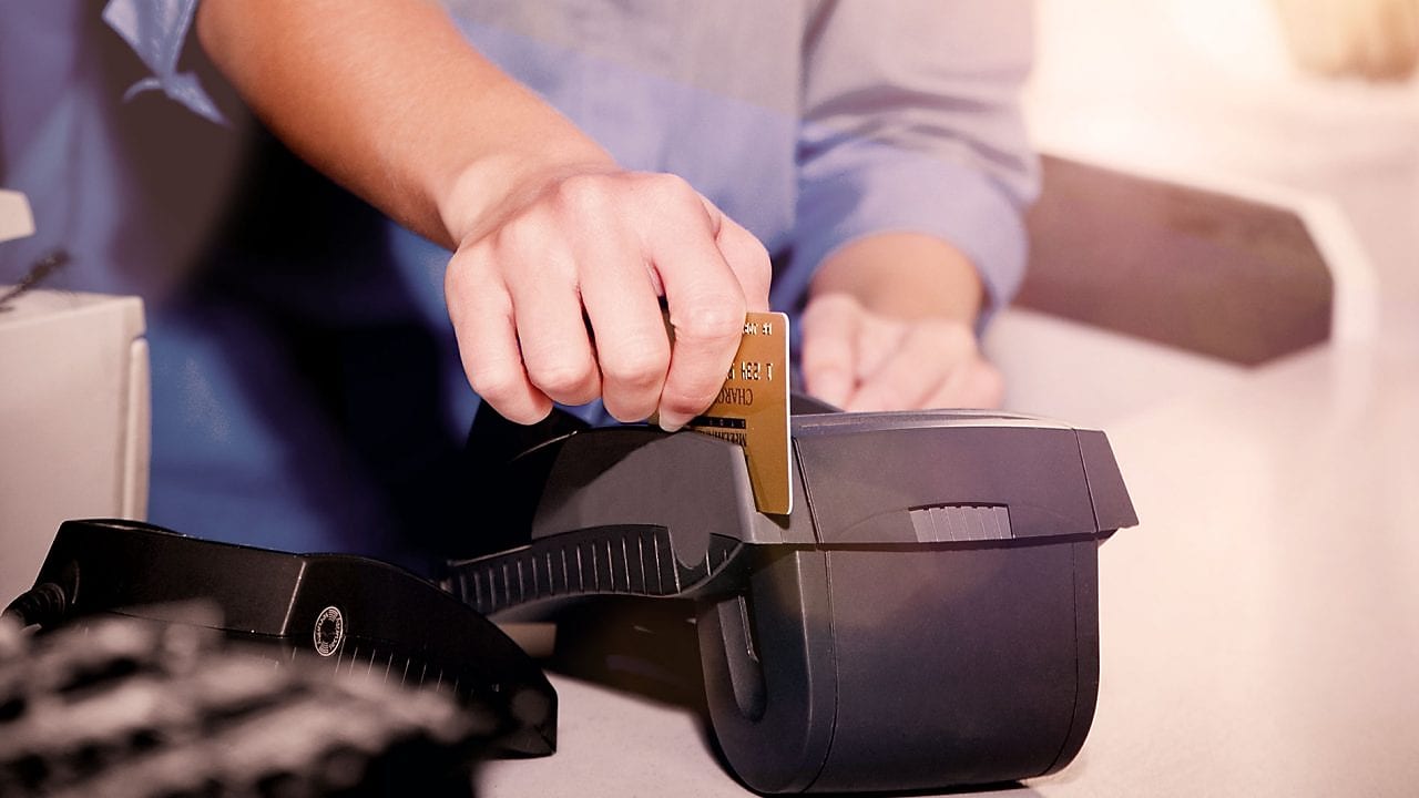person swiping creditcard