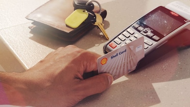 Person swiping shell card in reader machine