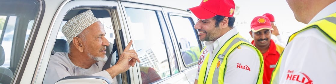 Shell helix attendants talking to a customer in a car