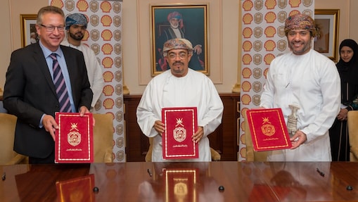 Three men holding certificate