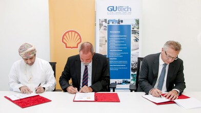 Three men signing an agreement