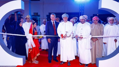 Oman Shell people celebrating anniversary by cutting ribbon