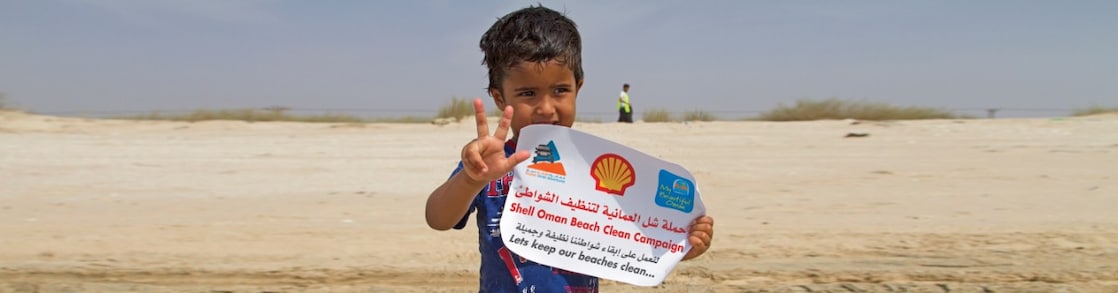 Little Boy holding the shell paper