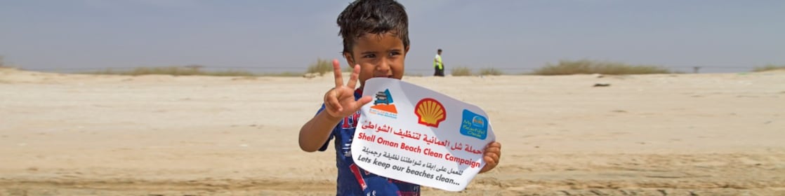 Little Boy holding the shell paper
