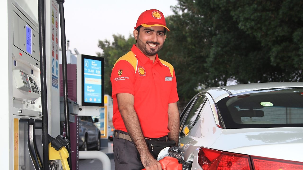 Shell employee filling gas in a car