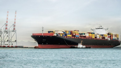 Large tanker at sea loaded with container crates
