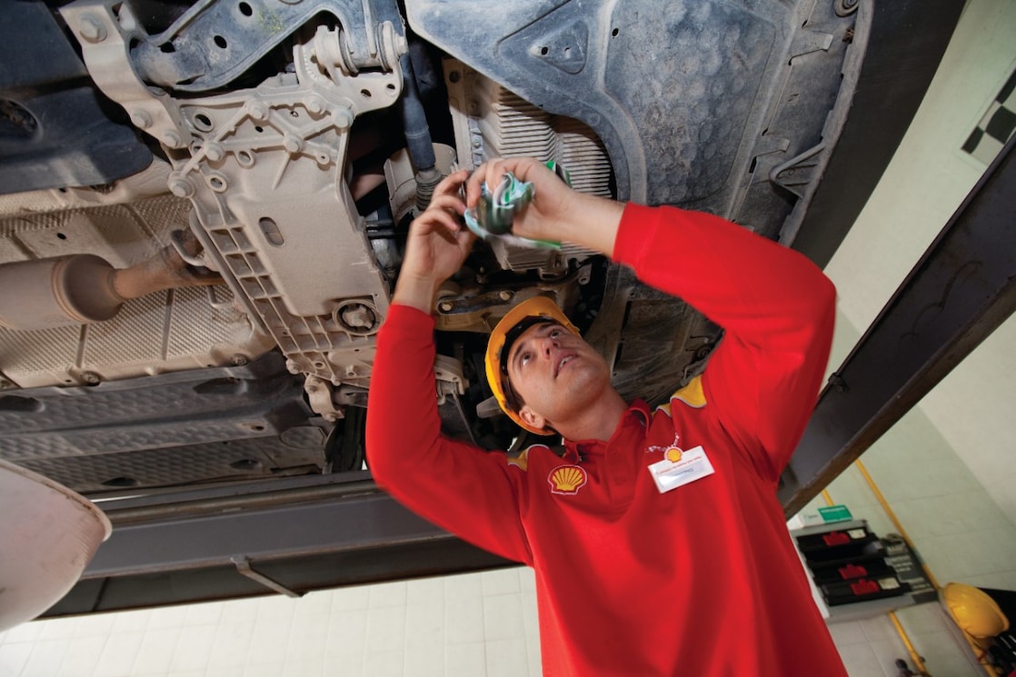 Employee doing fitting of parts in car