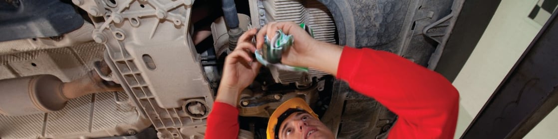 Employee doing fitting of parts in car