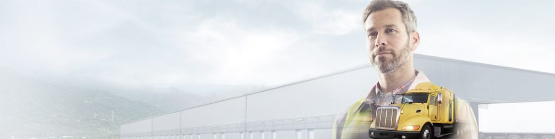 man reading a document transposed onto a background of a site and yellow truck