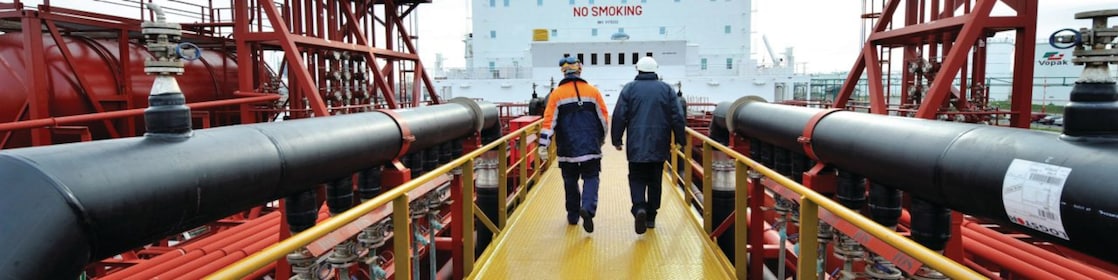 Shell employee walking along on a tanker 