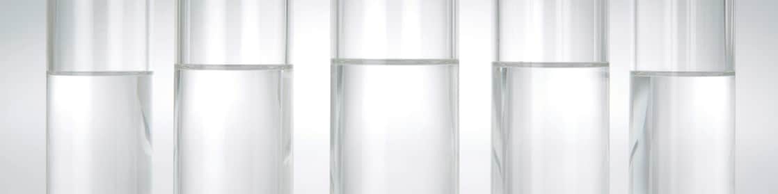 Five beakers in a row with a clear liquid in each one