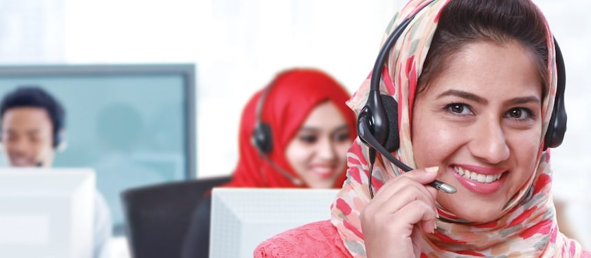 Women wearing headphones and mic answering calls in a call centre,Singapore 2008