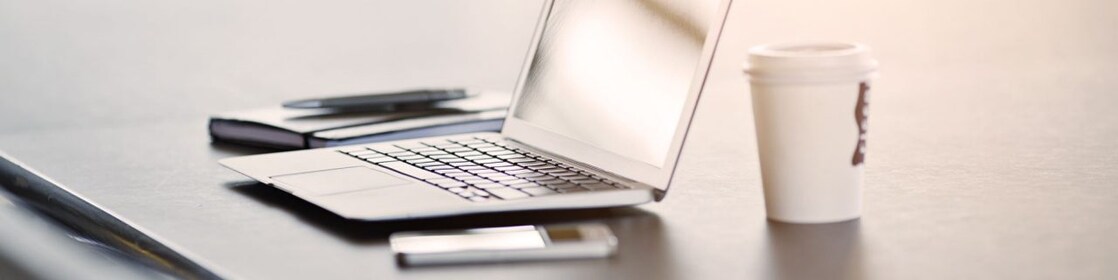 laptop, mobile phone and coffee on a desk
