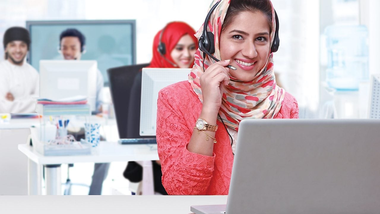 Women wearing headphones and mic answering calls in a call centre,Singapore 2008