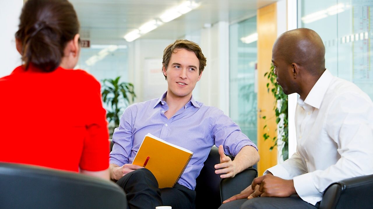 two employees interviewing a potential candidate