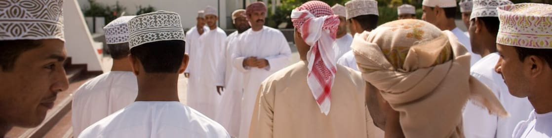 Omani locals gathering infront of building
