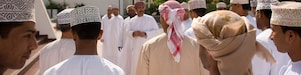 Omani locals gathering infront of building