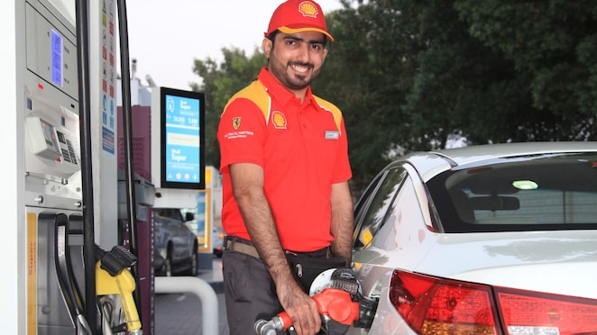 Shell employee filling gas in a car