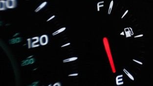 Dashboard display in car showing low fuel