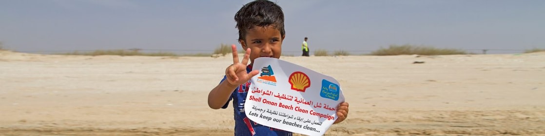 Little Boy holding the shell paper