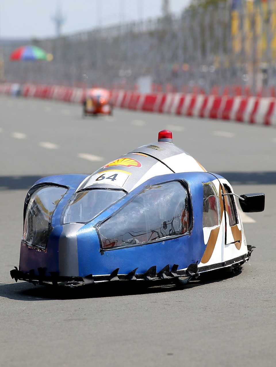 The Mean Machine, #64, Prototype, competing for Team Megalodon from The German University of Technology, Oman runs on the track during day four of the Shell Eco-marathon in Manila, Philippines, Sunday, March 1, 2015.